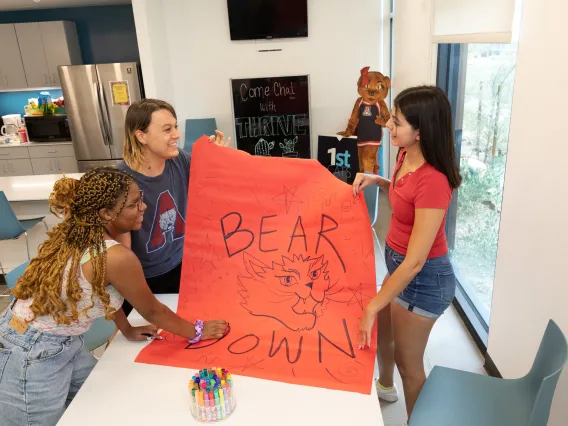 Students with Bear Down Poster